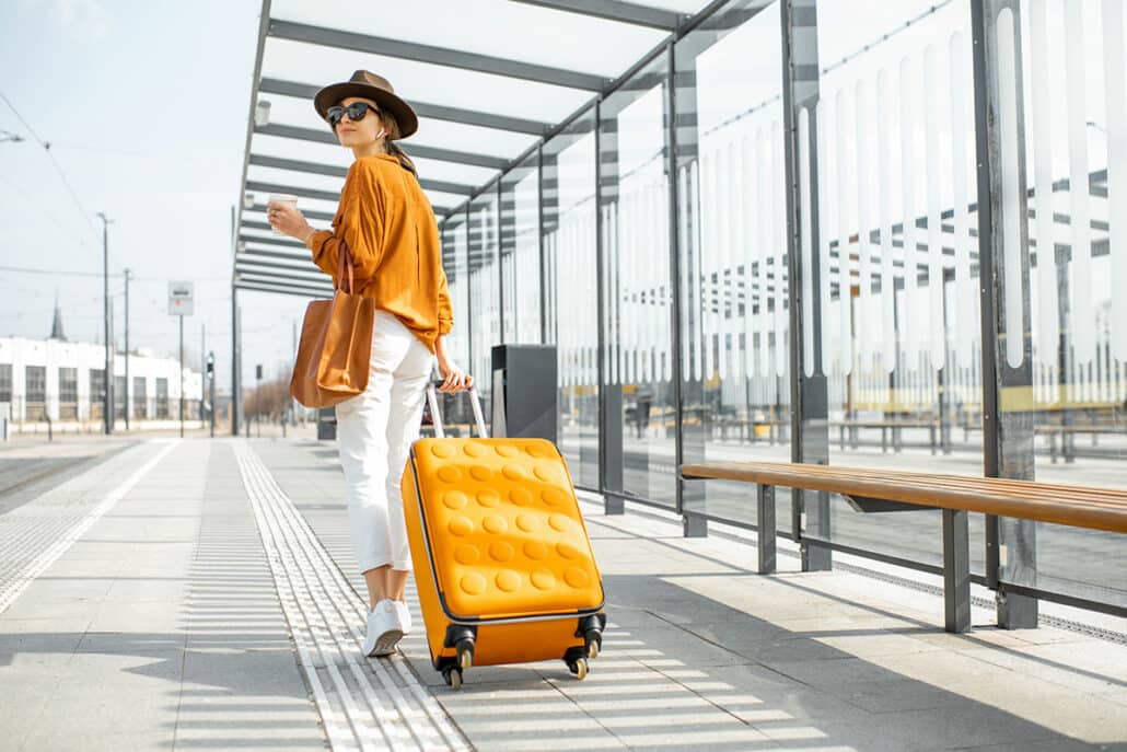Woman in an airport preparing to travel after a rhinoplasty procedure.