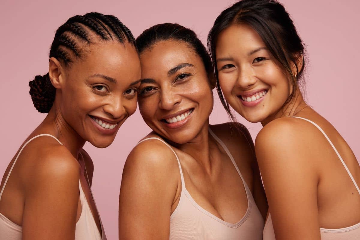 Smiling women of different ethnic backgrounds highlighting natural, balanced results of ethnic rhinoplasty.